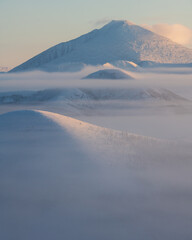 Fog on the Olchansky pass in the Oymyakonsky district. Morning landscape of snow-capped mountains. Foggy landscape of the coldest place on Earth - Oymyakon - 406668926