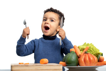 Fun portrait of afro american kid in front of bowl with vegetables