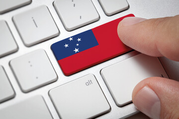 Online International Business concept: Computer key with the Samoa on it. Male hand pressing computer key with Samoa flag.