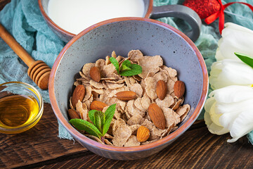 Spelt flakes with milk on breakfast. Light breakfast on Valentine's day with tulips and heart