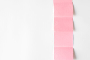 Collection of pink stickers on white wall, copy space