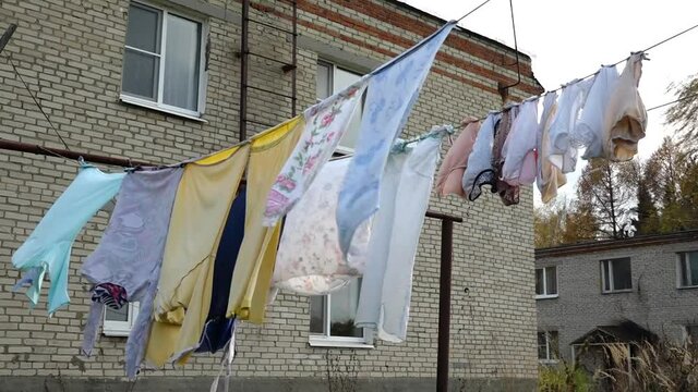 The laundry is dried outside. Clothes after washing dries on a rope outside.