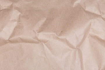 Background of gray brown slightly crumpled wrapping paper, fragment, texture