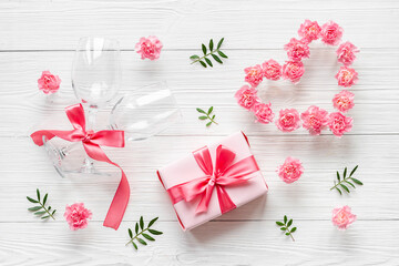 Valentines Day pattern of pink gift box and flowers. Overhead view