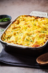 Traditional shepherd's pie with meat and mashed potatoes in black backing dish. Comfort food concept.