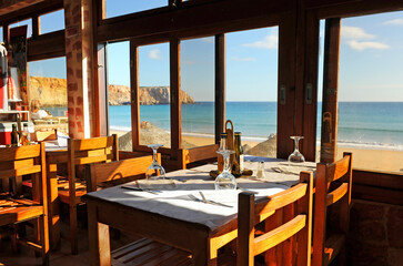 Panoramic view of Sagres beach from inside a restaurant. Algarve, south of Portugal.