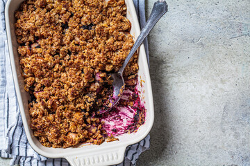 Homemade berry oat crumble pie in backing dish. Comfort food concept.