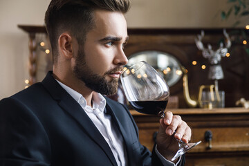 Handsome bearded man with a glass of red wine