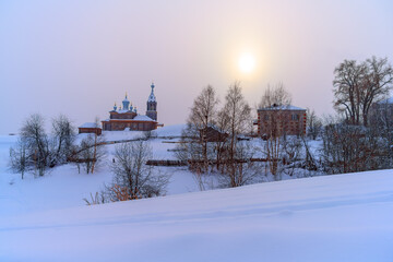 Winter in Cherdyn (Northern Urals, Russia) - a city on 3 hills. a thick layer of even, clean snow covered the mountains, ancient churches, buildings and trees. a light fog descended from frost