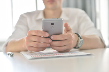 Financial auditor with smart phone checking business plan.