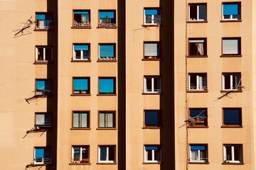 window on the orange facade of the house, architecture in Bilbao city, Spain