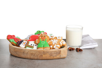 Obraz premium Tasty Christmas cookies near glass of milk on table against white background