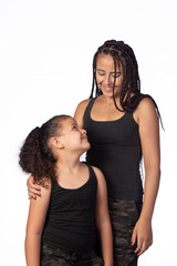 Mother and daughter dressed alike in a very happy rehearsal, white background, selective focus.