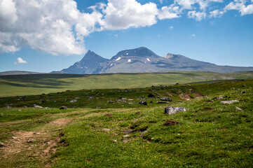 Clouds over tranquil alpine meadows and slopes of Aragats mountain in Armenia