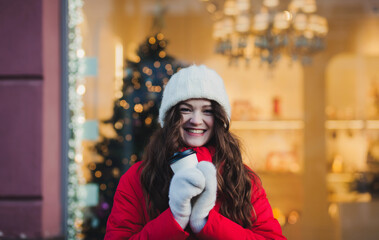 happy woman smiles holding a warming tea