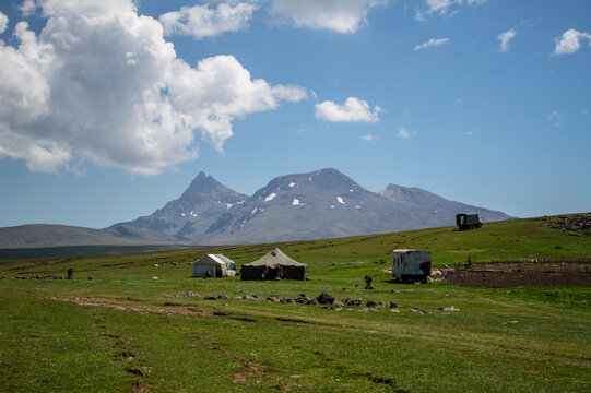 Aragats, Armenia - August 10, 2020: Tents of Yazidi nomad shepherds in the mountains of Armenia with mount Aragats in the background