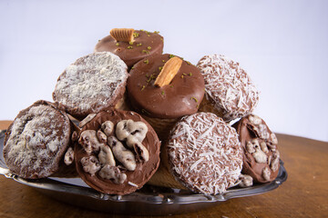 Sweet, ice cream cone filled with chocolate and cream with chocolate flakes, on a tray over rustic wood, gray background, selective focus.