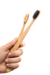 Female hand with a eco-friendly bamboo toothbrushes