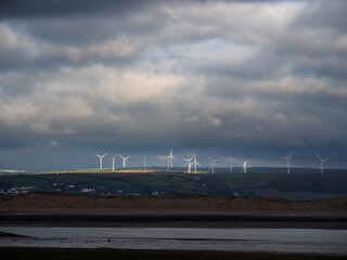 Fototapeta premium View from Northam Burrows to Fullabrook wind farm, North Devon, England on a stormy day.