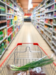 Abstract blur in supermarket with shopping cart.