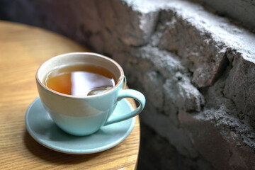 Cup of hot tea next to windows,