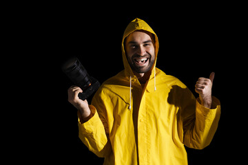 Cheerful photographer showing thumb up posing with digital camera