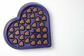 heart-shaped chocolate pralines lie in a box, which is also heart-shaped