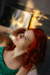 Fototapeta premium portrait of a red-haired girl in the studio of a young woman