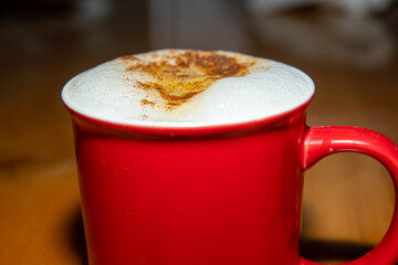 Cup of latte with milk foam and cinnamon