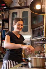 young woman is preparing in the kitchen. recipe from your smartphone. Healthy Lifestyle. Cooking At Home. vertical photo