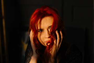 portrait of a red-haired girl in the studio of a young woman