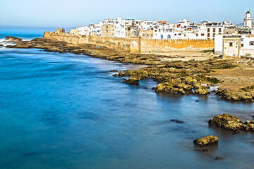 Scenic long exposure view of Essaouira fortress, coastline and medina against sea and rock, Morocco. With selective focus