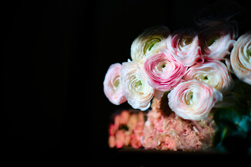 Background for a holiday card for Valentine's Day or March 8. Flowers on a dark background on a wooden old table.