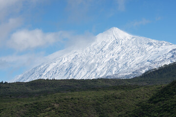 Fototapeta premium Pico del Teide mountain volcano in snow, bright blue sky. Teide National Park, Tenerife, Canary Islands, Spain