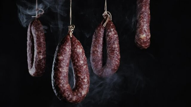 Motion of tasty salami rings in a smokehouse.