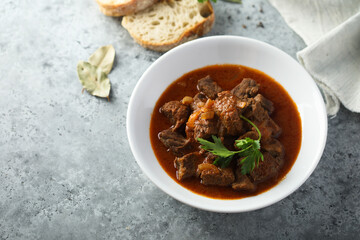 Traditional homemade beef goulash with fresh parsley