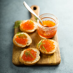 Naklejka na ściany i meble Red caviar on toast with dill
