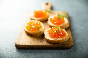 Red caviar on toast with dill
