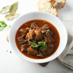 Traditional homemade beef goulash with fresh parsley