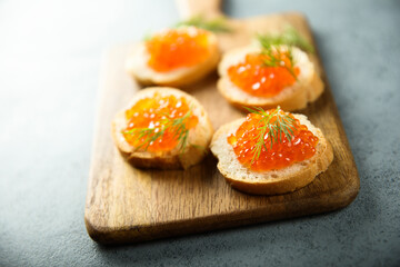 Red caviar on toast with dill