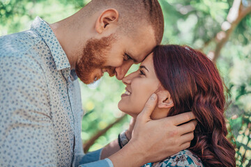Beautiful young couple in park. Love and emotions concept.