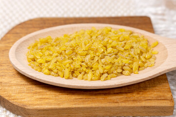 raw grain Bulgur porridge. Healthy, dietary, vegan, gluten free product. Organic product made from wheat grains. Close-up.