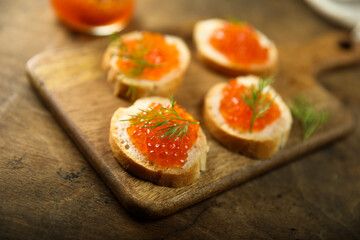 Red caviar on toast with dill