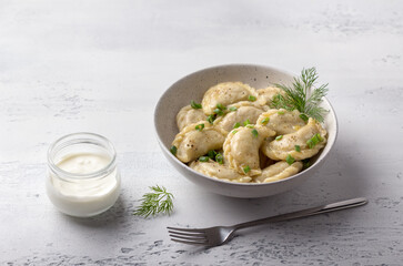 Homemade vegan dumplings, vareniki, pierogi, kreplach stuffed with vegan lentil "meat", carrots, onions, herbs and spices on light textured background