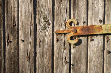 Old decorative hinge on a wooden door