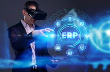 Business, Technology, Internet and network concept. Young businessman working on a virtual screen of the future and sees the inscription: ERP