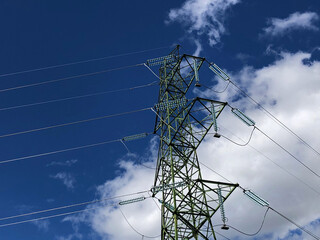 Electricity transmission tower against blue sky