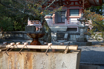 Fototapeta na wymiar The chozu-bachi in water ablution pavilion (Chozuya) at Chion-in temple complex. Kyoto. Japan