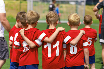 Youth Soccer Team Substitute Players. Boys Standing in a Row Huddling During Penalty Kicks. Football Tournament Competition for Kids - obrazy, fototapety, plakaty