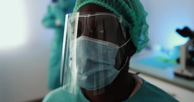 African man doctor at work inside hospital during coronavirus outbreak - Medical worker on Covid-19 outbreak wearing face protective mask